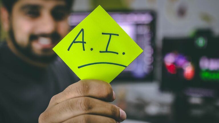 Person holding Post It note that says A I representing intelligent search results powered by artificial intelligence